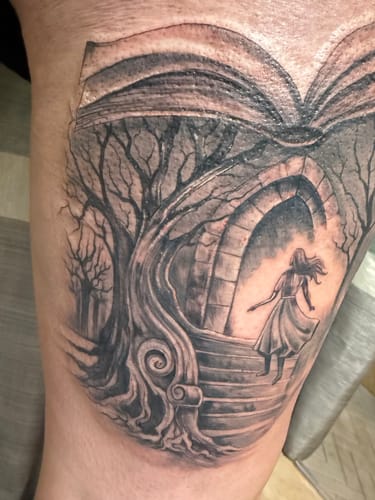 Close-up of a reviewer's new, large thigh tattoo of a fantasy scene after using the Painless Tattoo Numbing Cream.