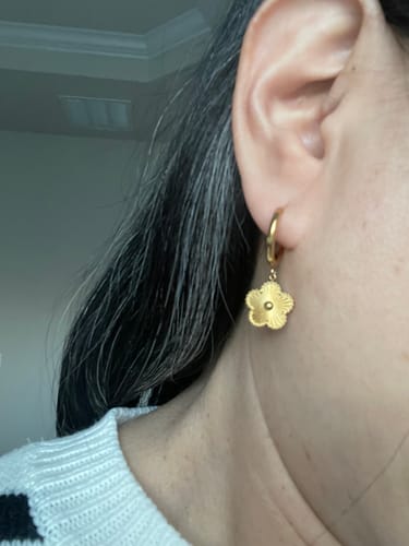 Close-up of a reviewer wearing the dainty Golden Clover Hoop Earring on their ear.