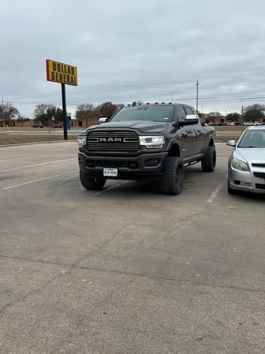 Customer's gray Dodge Ram truck parked in a lot, showing its raised stance after installing the front lift kit.