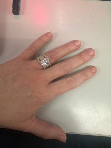 A customer's hand wearing the Silicone Ring Stackable Set, showing the large oval-cut stone.