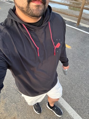 Customer wearing the black Naruto Akatsuki performance hoodie with red drawstrings outdoors.