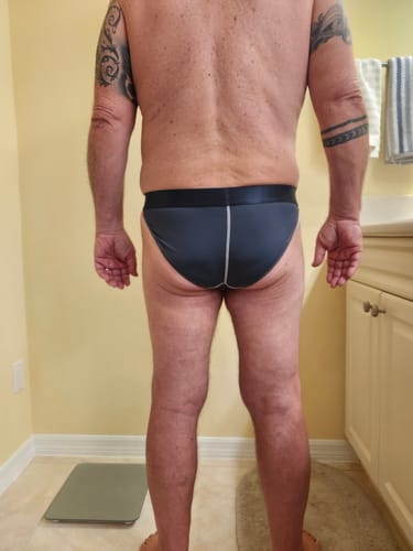 Reviewer showing the back coverage of the dark gray Nylon Mesh Bikini Briefs.