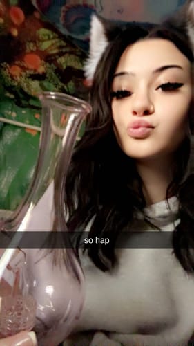 A reviewer holds up their new pink Rose in Vase Glass Water Pipe.