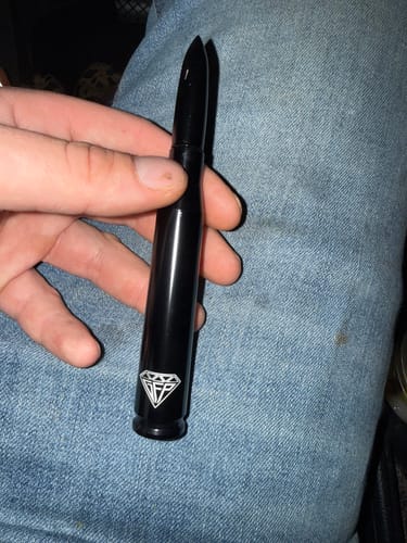A customer holding the shiny black Premium Bullet Antenna in their hand, showing the GFP diamond logo.