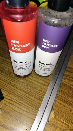 Reviewer's Her Fantasy Two Pack Wash, showing the red Yummy and speckled Refresh bottles on a table.