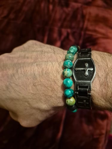 Customer's wrist wearing the Phoenix Rising bracelet, highlighting its turquoise and black lava beads.