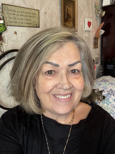 Reviewer smiling, showing improved skin after using the Grass Fed Tallow & Honey Balm for one month.