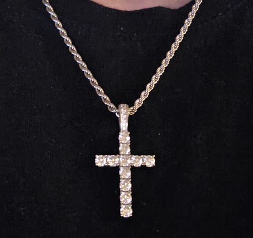 Customer wearing the sparkling Cross Piece Pendant on its silver-colored rope chain.
