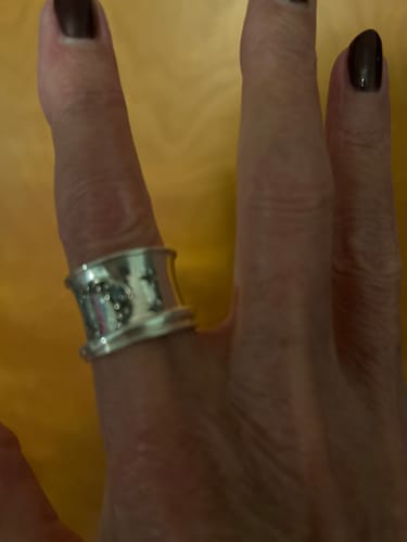 A customer's hand wearing the wide Aquamarine Stars and Moon Fidget Ring.