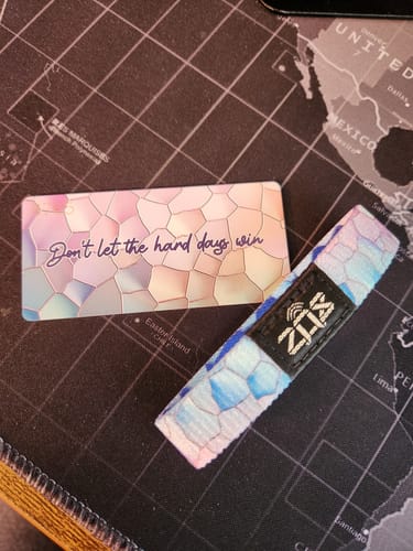 Reviewer's 'Don't Let the Hard Days Win Bracelet' with its colorful pattern, shown next to the inspirational card.