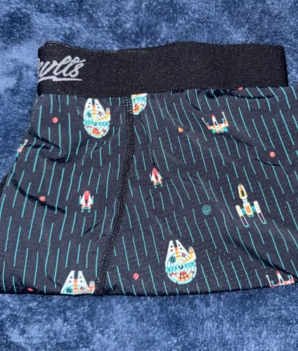 Customer's close-up of the Star Wars 'Rebel Rides' boxer briefs, showing the black waistband and colorful spaceship pattern.