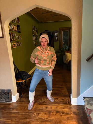 Reviewer gives a thumbs-up while wearing the Gwen Print Sweater with blue jeans and a beanie.