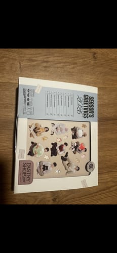 Customer showing the box for the ATEEZ 2026 Season's Greetings on a wooden surface.