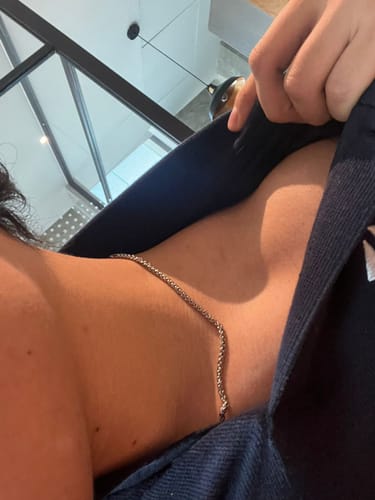 Close-up of a customer wearing the silver 3mm Wheat Chain around their neck.