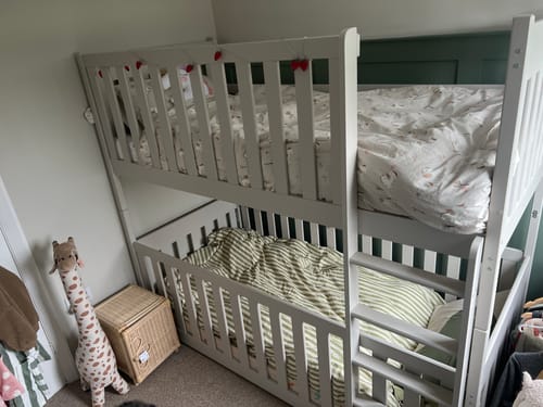 Reviewer's white Wooden Bunk Bed Konrad in a child's room, with the bottom bunk converted to a cot bed.