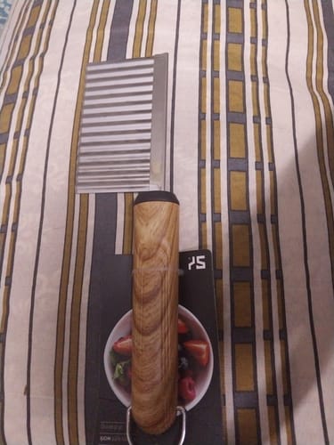 Customer's Wavy Cutter with a wooden handle and corrugated blade, shown on its original packaging.
