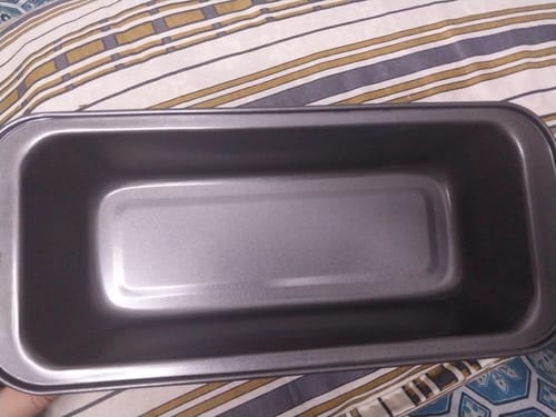 Customer's rectangular, dark grey Cake Baking Mold sitting on a striped surface.