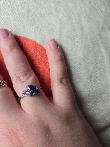 Reviewer's hand wearing the Leesha Birthstone Ring with a blue and a pink stone.