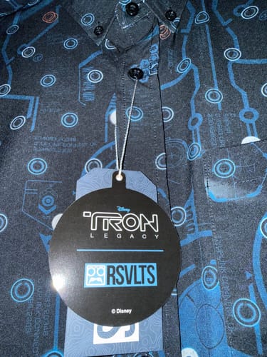 Customer's close-up of the Tron Legacy shirt, showing the dark fabric with its blue disc and circuit pattern.