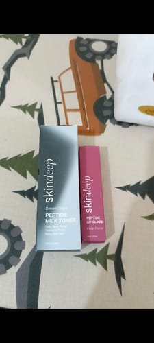 Customer's Peptide Lip Glaze in its pink box, displayed next to another Skindeep product.