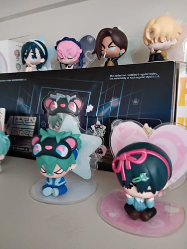 Customer's collection of colorful Alien Stage Blind Box Figures displayed on a shelf with their packaging.