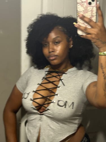 Reviewer wearing the grey Matte Logo Tee, showing the prominent black lace-up detail on the front.