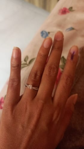 Customer's hand wearing the Silver Zircon Layered Ring, showing the detailed band and central stone.