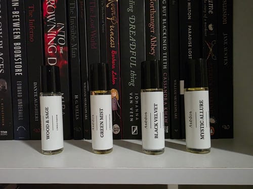 Reviewer's MYSTIC ALLURE PERFUME OIL roll-on bottle shown with three other scents on a white shelf.