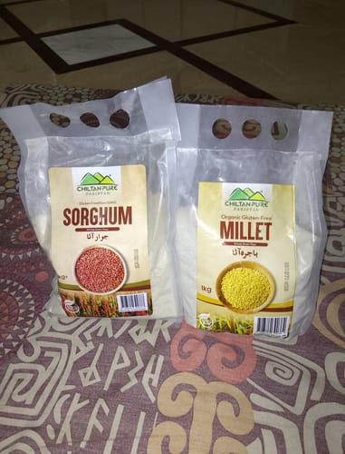 Customer's bags of Chiltan Pure Millet Flour and Sorghum Flour sitting on a patterned surface.