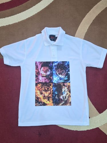 Customer's white polo shirt with a colorful four-panel anime graphic, a result of the DTF printing guide.
