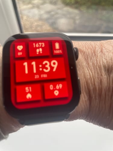 Close-up: A customer's Gard Pro Health Smartwatch 3 on their wrist, showing a bright red display with health stats and 100% battery.