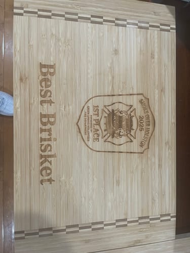 Customer's engraved wooden cutting board, a '1st Place Brisket' prize won using the Cow Cover Rub.