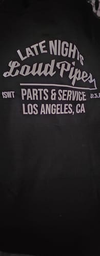 Customer's black T-shirt from the TCG90 MYSTERY CASH BOX with "Late Nights Loud Pipes" printed in white.