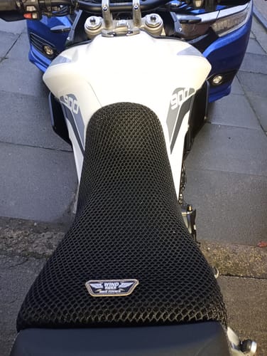 Customer's black mesh Wind Rider Seat Cover fitted on a white Triumph Tiger 900 motorcycle.