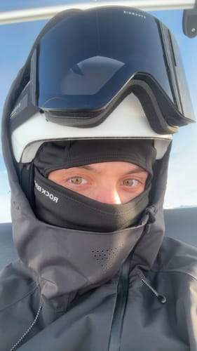 Close-up of a reviewer wearing the waterproof snow jacket with the hood up, showing the face venting system.