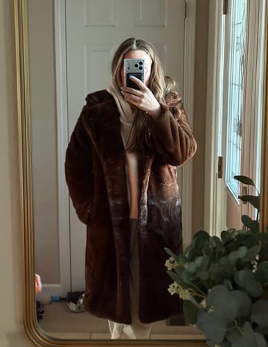 Reviewer wearing the brown Lucie Faux Fur Maxi Coat in a mirror selfie.