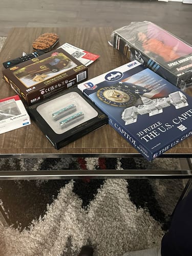 Customer's box for the US CAPITOL BUILDING puzzle shown on a table with several other new toys.