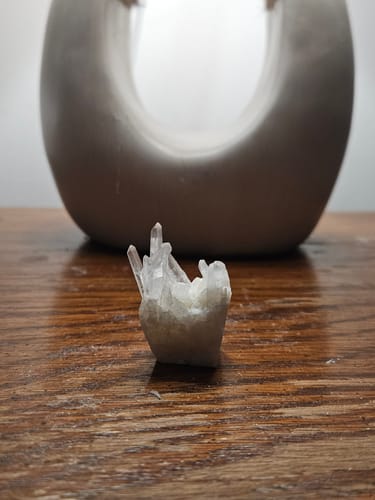 Customer's beautiful clear crystal cluster from the VIP Crystal Club sitting on a wooden surface.