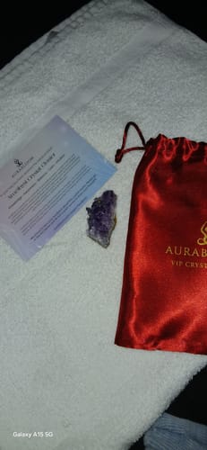 Customer's amethyst crystal cluster, info card, and red satin pouch from the VIP Crystal Club subscription.