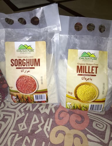 Customer's clear package of Sorghum Flour sitting on a patterned surface next to another bag of flour.