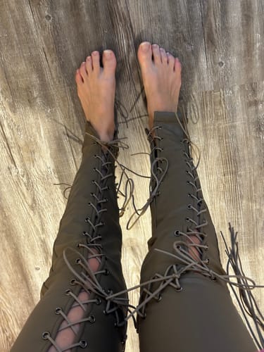 Top-down view of a reviewer wearing the tan Vice Pant, showing the front lace-up detail and ankle length.