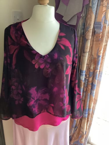Customer's cerise viscose jersey fabric used as a bright base layer for a top on a mannequin.
