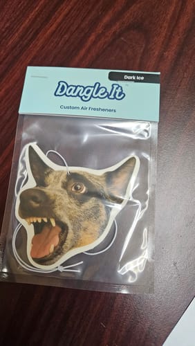Customer's new custom air freshener in its packaging, with a photo of a dog playfully baring its teeth.