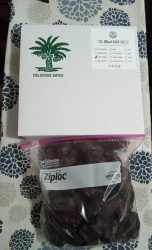 Reviewer's Organic Large Medjool Dates in a storage bag next to the white product box.