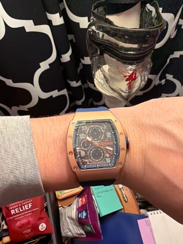 Customer wearing their Lucky Fours® Polaris watch, showing the rose-gold colored case and blue strap.