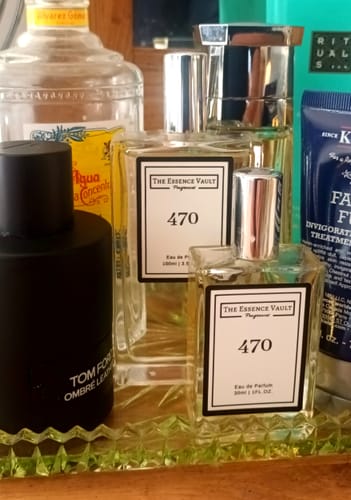 Reviewer's two bottles of No. 470 fragrance displayed next to a bottle of Tom Ford Ombre Leather.