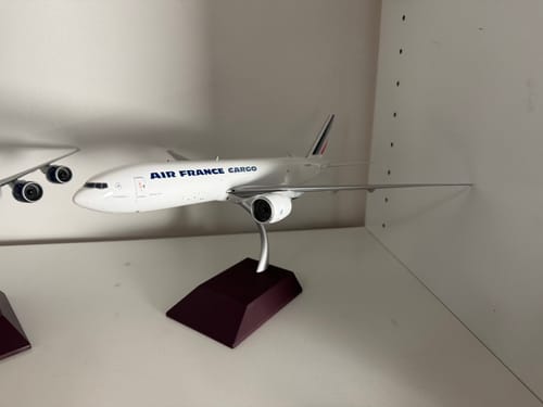 Customer's Gemini200 Air France Cargo 777F die-cast model airplane displayed on its stand on a shelf.