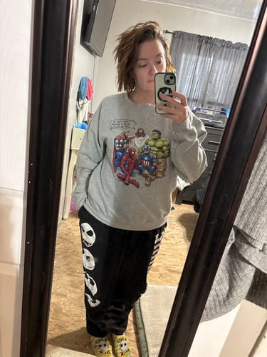 Reviewer wearing the How I Saved The World Sweatshirt, showing its loose and comfortable fit in a mirror selfie.