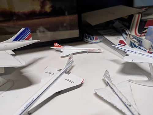 Reviewer's HERPA BRANIFF CONCORDE 1/500 model displayed as part of a collection of other model airplanes.