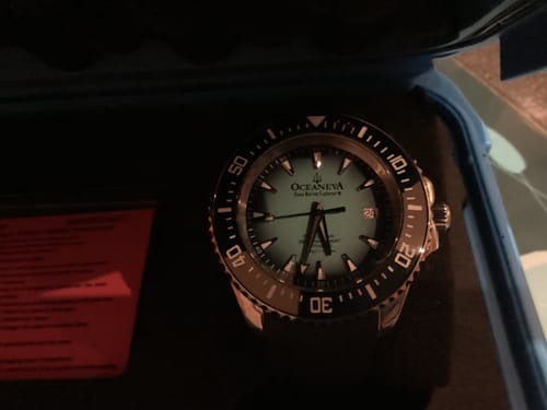Customer's Oceaneva 6000m watch with a mint dial and black bezel, seen from above in its case.